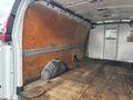 Interior view of a 2022 GMC Savana cargo van showing a spacious cargo area with wooden walls and a flat floor