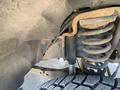 Close-up of the suspension system on a 2016 Ford F-350 SD showing rusted coil springs and shock absorber components