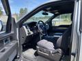 2014 Ford F-150 interior showing driver's seat steering wheel and dashboard with controls