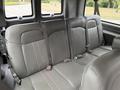 Rear seats of a 2021 Chevrolet Express van with gray upholstery and seatbelts.