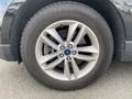 A close-up of a 2017 Ford Edge wheel featuring a silver alloy rim with five spokes and a Goodyear tire