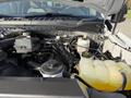 Engine compartment of a 2021 Ford F-250 SD showing various components such as the coolant reservoir and air intake system