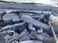 Engine compartment of a 2015 Ford F-450 SD with various hoses and components visible including air intake and radiator connections