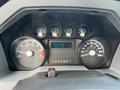 Dashboard of a 2014 Ford F-250 SD showing various gauges including speedometer odometer and engine hours display