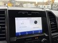 Dashboard display of a 2020 Ford F-550 showing radio station and settings options