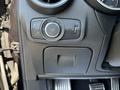 The image shows the control panel of a 2020 Alfa Romeo Stelvio featuring various dials and buttons for vehicle functions and settings