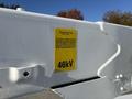 A close-up of a label on a white Freightliner M2 106 showing the text Powertech and the voltage rating 46kV