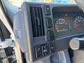 Close-up of the dashboard controls in a 2016 Isuzu NPR-HD including air conditioning vents and various buttons for vehicle functions