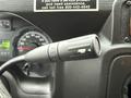 Close-up of the turn signal lever from a 2017 Ford E450 featuring a black handle with markings for turn signals