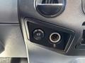 Interior dashboard control panel of a 2016 Ford F-750 featuring a power button and a circular power outlet socket
