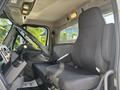 Interior of a 2022 Freightliner M2 106 featuring a driver's seat and steering wheel with controls visible