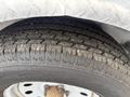 A close-up of a tire from a 2016 Continental cargo trailer showing worn tread patterns and a metallic rim