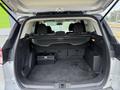 Interior of a 2015 Ford Escape trunk showing ample cargo space with a storage box and two rear seats visible in the background