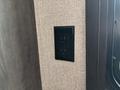 A black electrical outlet mounted on a textured wall inside a 2021 Jayco Jay Flight