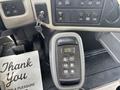 A control panel inside a 2013 International WorkStar featuring buttons and a digital display along with a key in the ignition