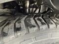 Close-up of a 2016 Ford Transit tire featuring a tread pattern with visible wear and dirt on the rubber surface