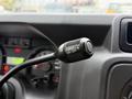A black switch on a stalk labeled with positions for on and off settings in a vehicle dashboard interior