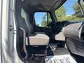Interior view of a 2014 Freightliner M2 106 showing the driver's seat dashboard and controls