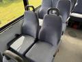 Interior seating of a 2017 Chevrolet Express with gray fabric seats arranged in pairs and equipped with seat belts