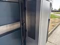 A 2020 Mercedes-Benz Sprinter 2500 with a partially opened side door revealing an empty storage compartment