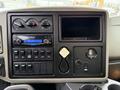 Dashboard of a 2012 International 7400 featuring climate controls audio system and various switches and gauges