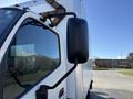 2014 Hino 195 delivery truck side mirror in focus with a white cargo area and clear glass window