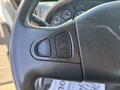 Close-up of the steering wheel of a 2013 International 7500 showing the cruise control and throttle buttons on the left side