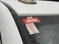 A 2012 Dodge Ram 5500 with a red and white certificate of approval sticker attached to the windshield displaying the months January to June