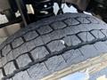 Close-up of a worn tire on a 2019 Ford F-550 showing deep tread patterns and a small puncture in the rubber