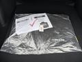 A 2025 Toyota Corolla floor mat is displayed in a plastic bag with a safety check notice on top