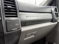 Close-up of the dashboard of a 2022 Ford F600 featuring the Super Duty branding along with various control knobs and a power outlet