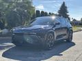 A black 2023 Fisker Ocean with a modern design featuring sleek lines and a distinct front grille parked on a street