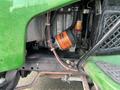 Close-up view of the engine compartment of a 2021 John Deere L Series (S) showing the engine components and an orange oil filter