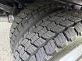 Close-up of the textured tread pattern on the tires of a 2020 Ford F-550 showcasing wear and deep grooves designed for traction