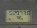 A digital display showing the odometer reading 52973.0 kilometers and a voltage reading of 14.1 on a dashboard panel