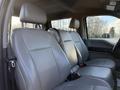 Interior view of a 2020 Ford F-550 showcasing four light gray upholstered front seats with seatbelts and a spacious cabin design