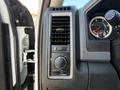 Close-up of the control panel of a 2016 RAM 5500 featuring air vents and various knobs for adjusting fan speed and climate settings