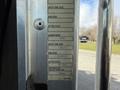 A metal placard on a truck door displaying specifications for a 2008 Kenworth T370 including tire size and pressure information