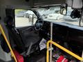 Interior of a 2020 Chevrolet Express with a driver's seat steering wheel dashboard and yellow handrails visible