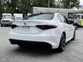 A white 2023 Alfa Romeo Giulia viewed from the rear showing its sleek design and distinctive tail lights