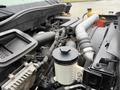 A close-up view of the engine compartment of a 2014 International TerraStar showing various components including hoses and a reservoir tank