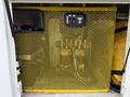 A 2011 Ford F-650 featuring a yellow mesh security gate covering storage compartments with visible controls and equipment behind it