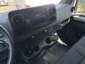 Interior view of a 2019 Mercedes-Benz Sprinter showing the dashboard with controls air vents and cup holders