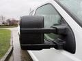 Close-up of the side mirror of a 2008 Ford F-250 SD with raindrops on it