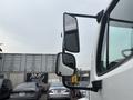 A 2006 Freightliner M2 106 truck with side mirrors reflecting a nearby vehicle in a parking lot