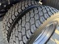 Close-up of two rugged tires with deep tread pattern designed for a 2010 Ford F-450 highlighting their robust build and durability