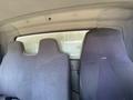 Interior view of a 2014 International TerraStar showcasing two upholstered front seats without armrests and a partition behind them