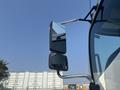 A close-up view of the side mirror of a 2012 Hino 338 truck showing two mirrors extending from the cab
