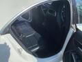 Interior view of a 2014 Mercedes-Benz CLA-Class showing the rear seats with black leather upholstery and a modern design