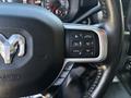 Close-up of the steering wheel of a 2021 RAM 5500 showing control buttons for cruise control and gear limit